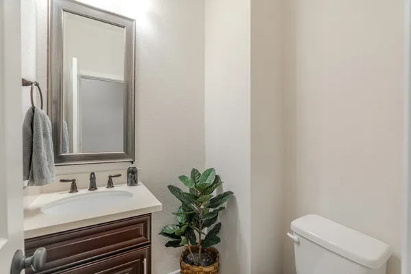 a bathroom with a sink a toilet and a mirror