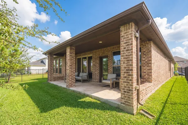 a view of a house with backyard porch and sitting area