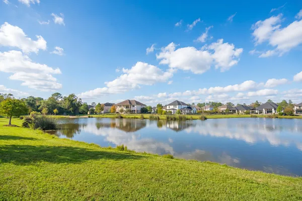 a view of a lake with houses in the back