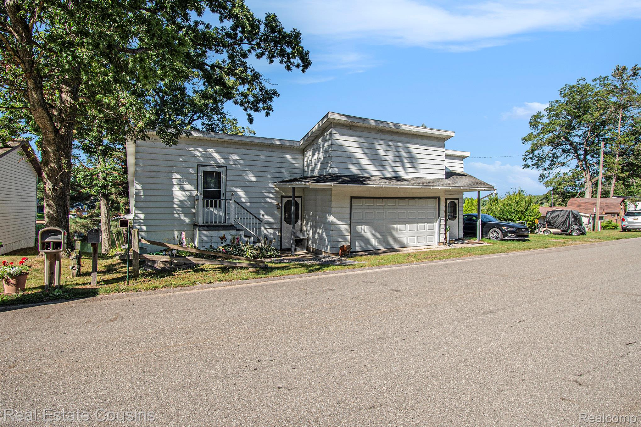 1734 Forest Road Harrison, MI 48625 - Photo 4 of 31 View of front of house with a garage