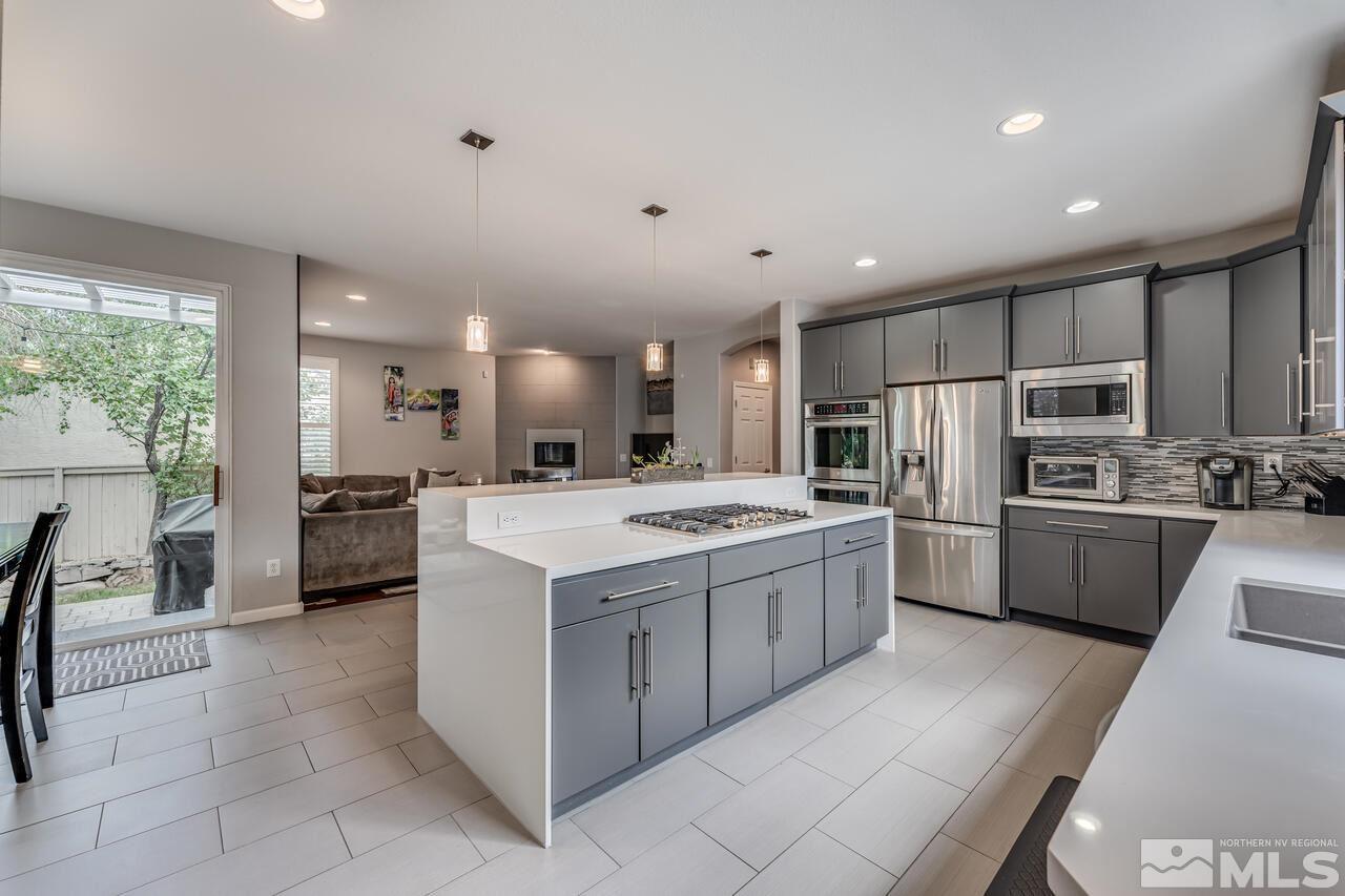 1735 Hunter Creek Road Reno, NV 89519 - Photo 8 of 30 a large kitchen with a large counter top stainless steel appliances and cabinets