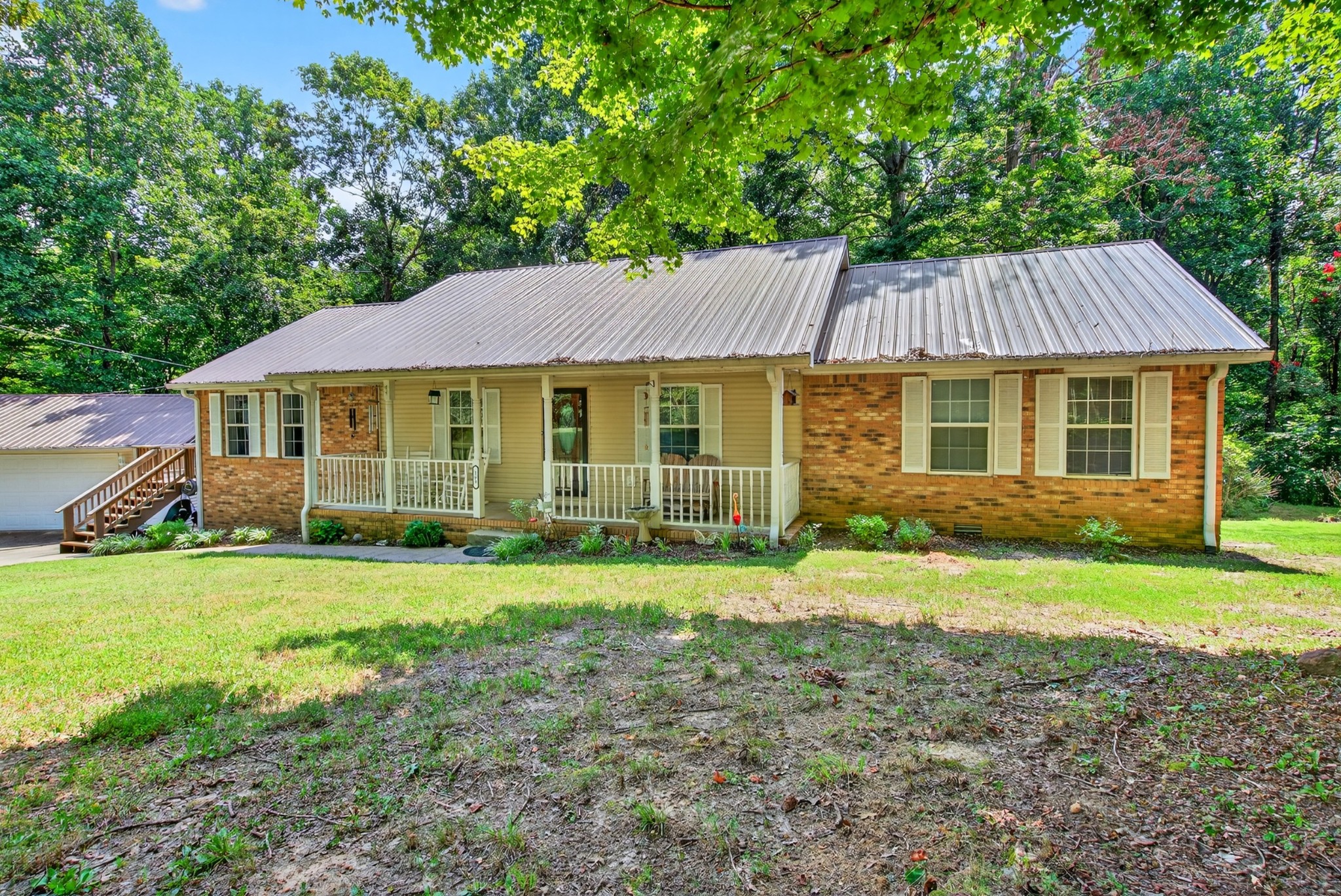 a front view of a house with a garden