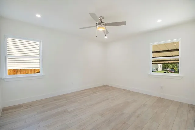 a bathroom with a toilet a sink a mirror a vanity and shower