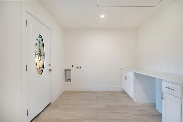 a view of a livingroom with wooden floor and white wall