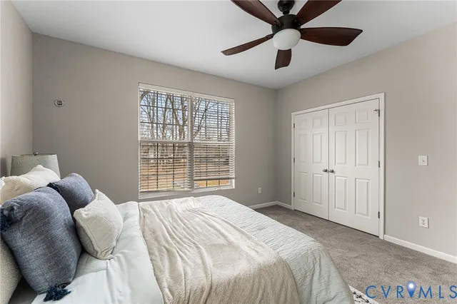 a bedroom with a large bed and a large window