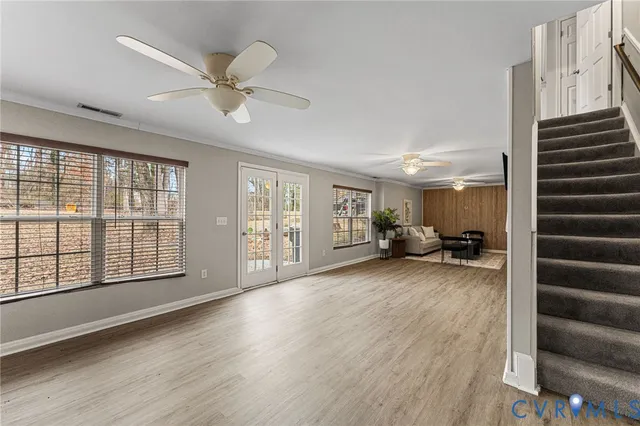 a view of a livingroom with furniture hardwood floor and staircase