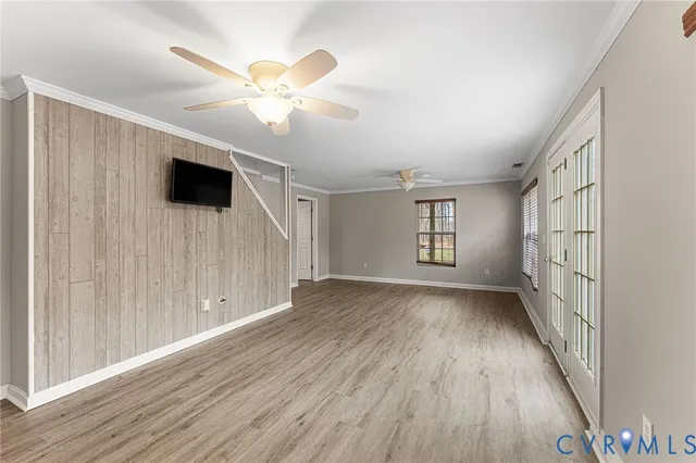 wooden floor in an empty room with a window