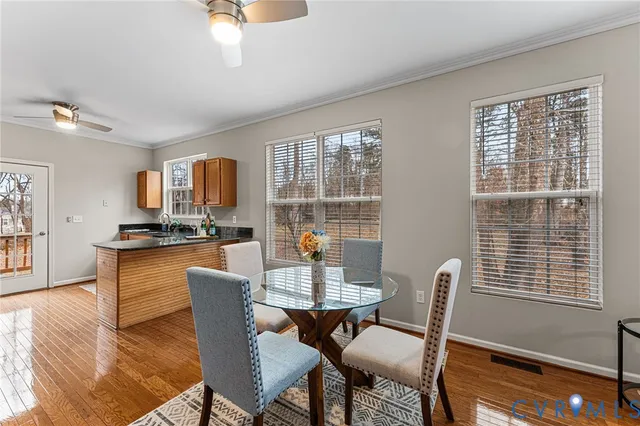 a dining room with furniture a rug and wooden floor