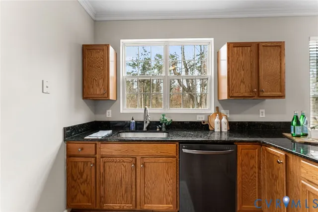 a kitchen with granite countertop cabinets sink and window