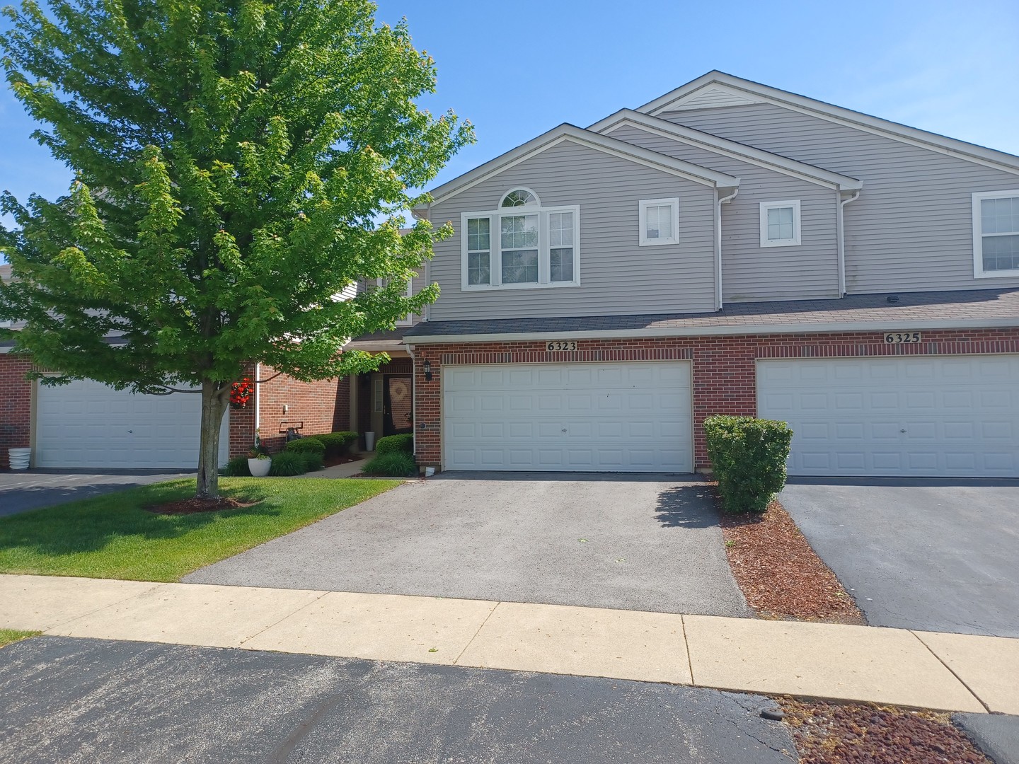 6323 Berry Path Trail, Unit 1093 Matteson, IL 60443 - Photo 1 of 15 a front view of a house with a yard and a garage
