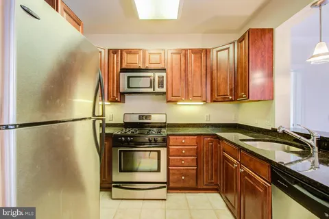 a kitchen with a refrigerator stove and microwave