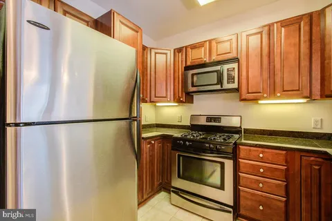 a kitchen with stainless steel appliances a refrigerator stove and microwave