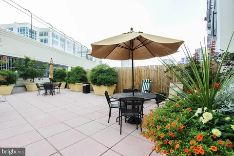 a view of backyard with seating space and wooden fence