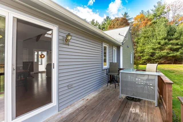 a view of a patio with table and chairs and wooden floor
