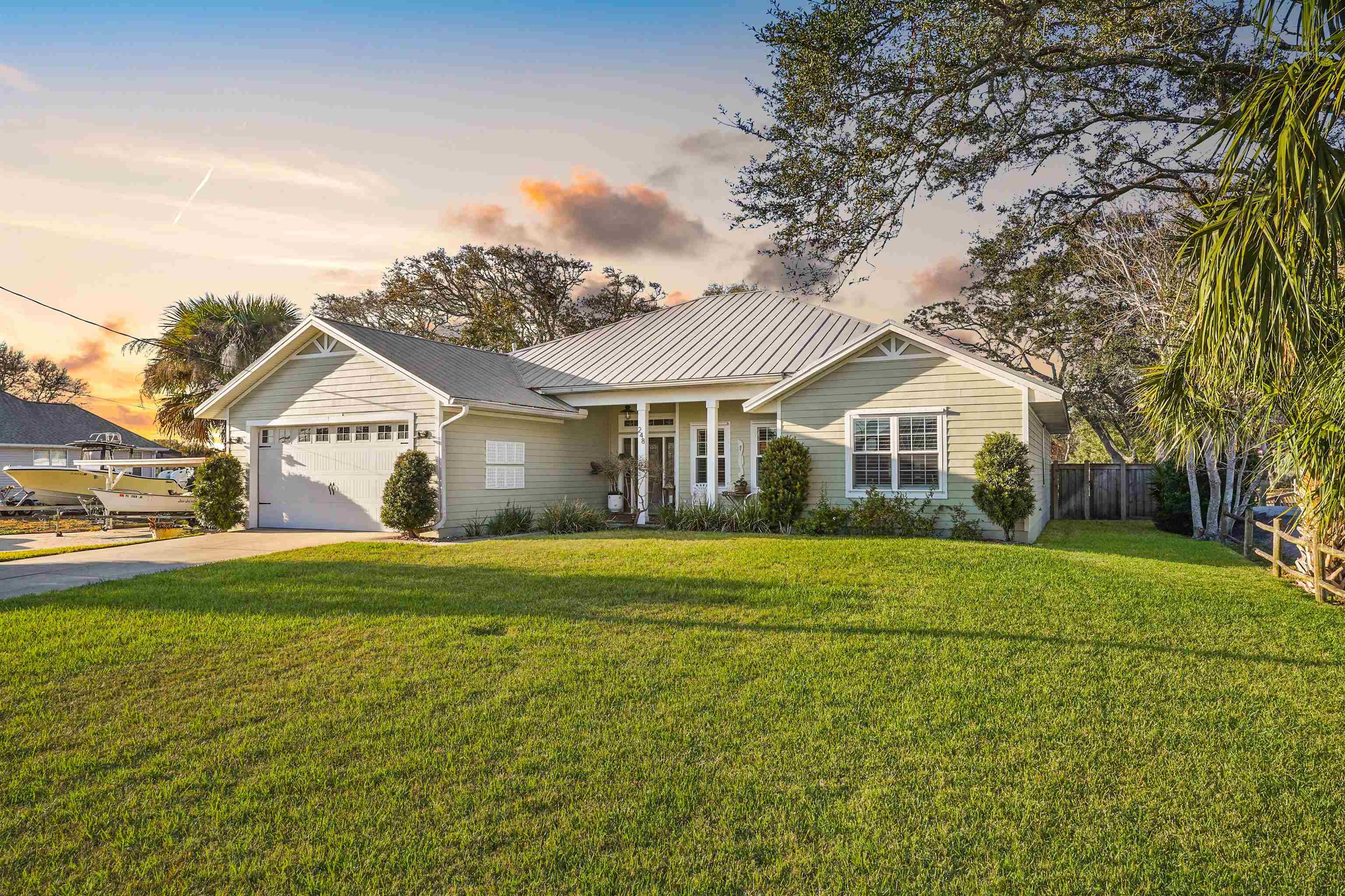 248 Pizarro Road St. Augustine, FL 32080 - Photo 2 of 53 Single story home with a metal roof, an attached garage, and driveway