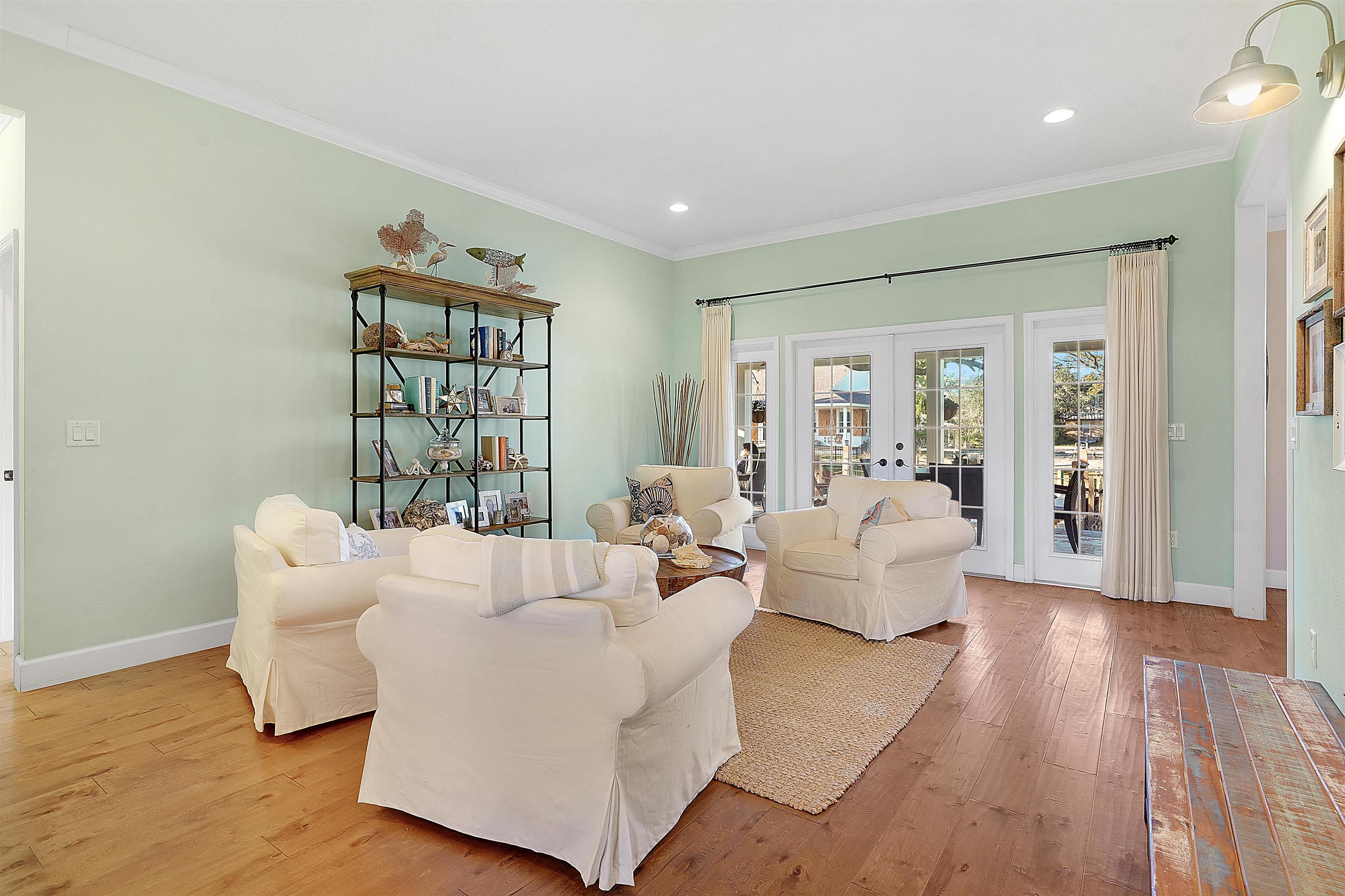 248 Pizarro Road St. Augustine, FL 32080 - Photo 21 of 53 Living room featuring french doors, light wood-style floors, crown molding, and recessed lighting
