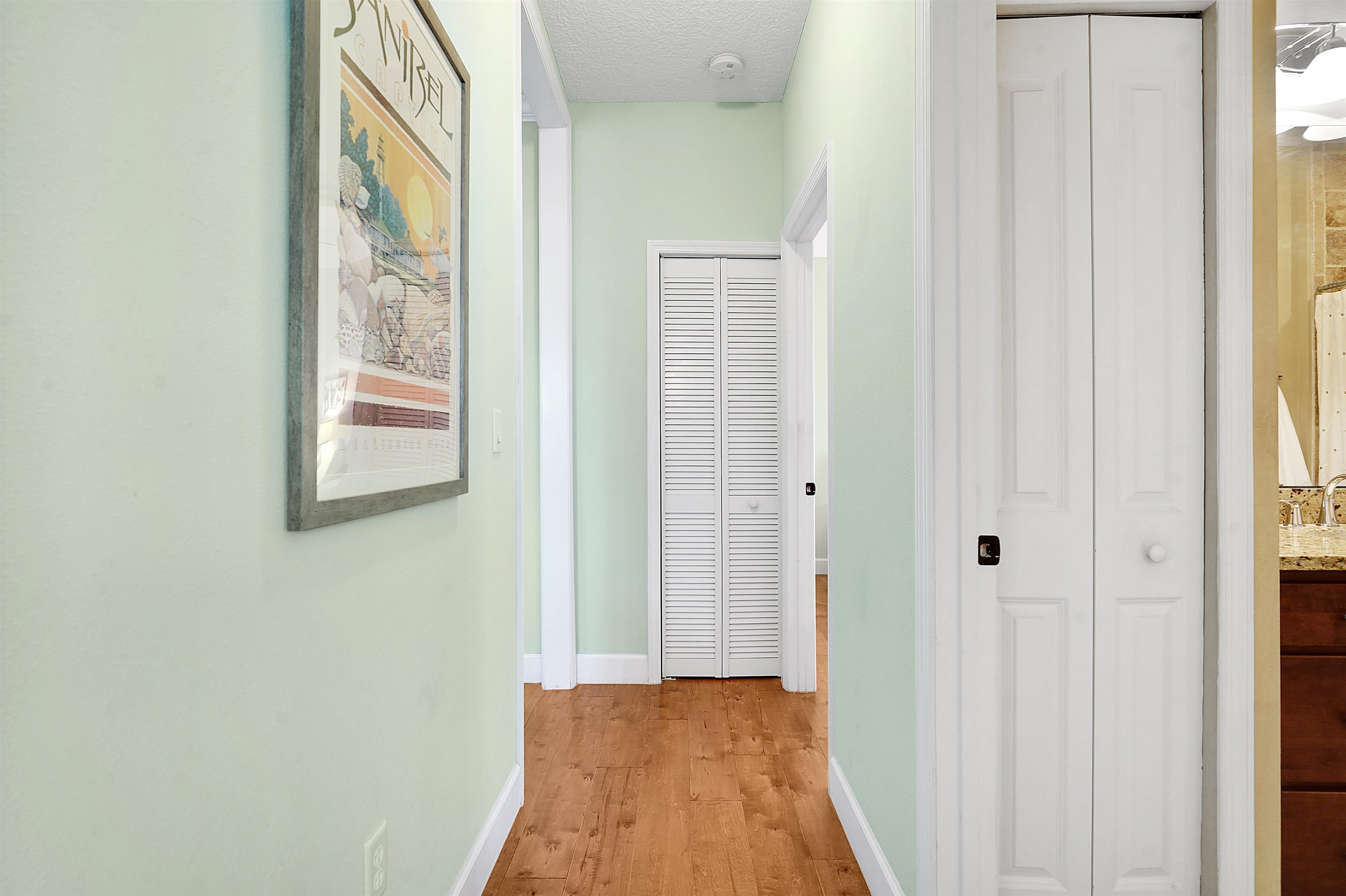 248 Pizarro Road St. Augustine, FL 32080 - Photo 23 of 53 Hall featuring light wood-style floors and a textured ceiling