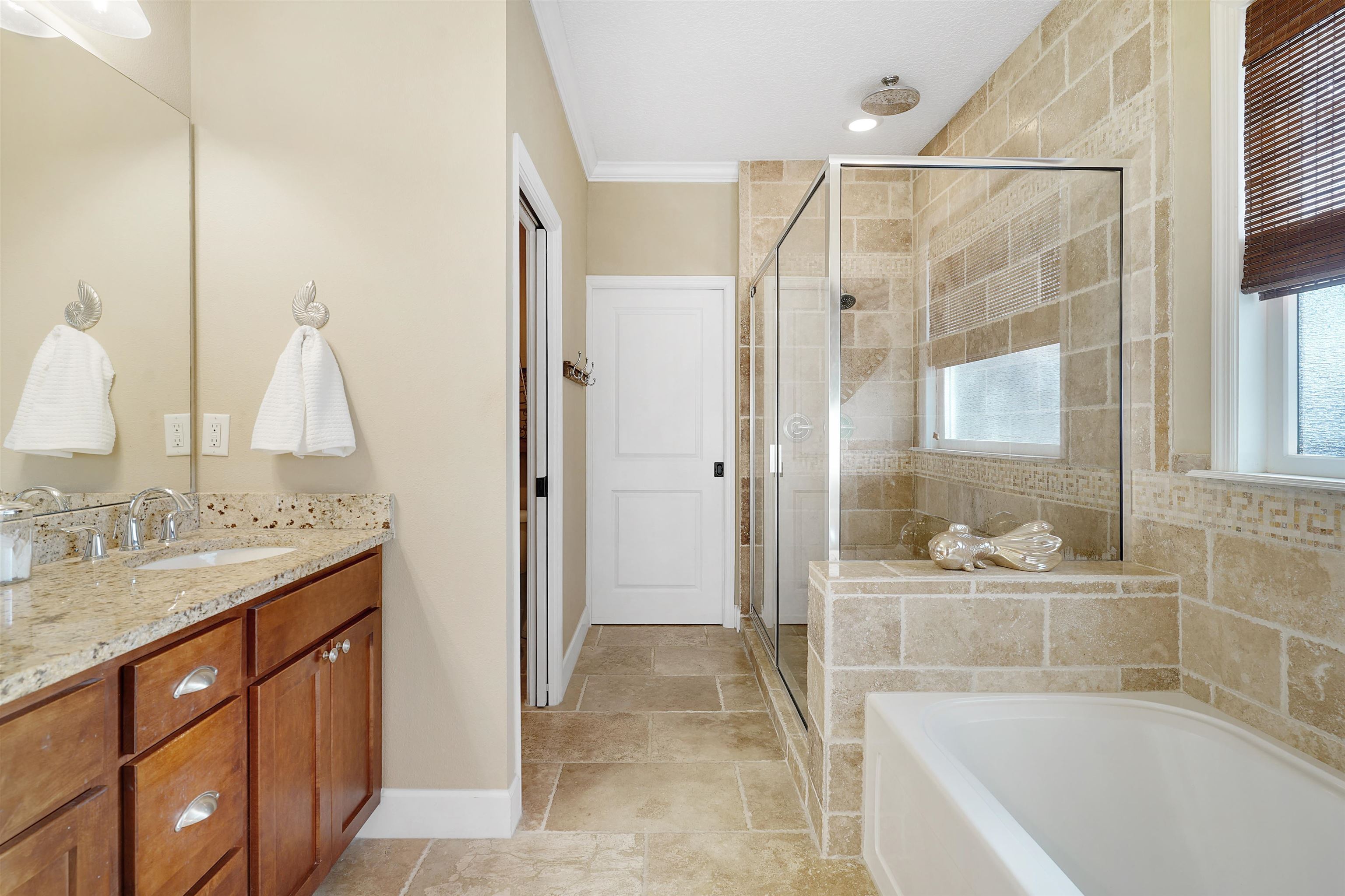 248 Pizarro Road St. Augustine, FL 32080 - Photo 28 of 53 Full bathroom featuring crown molding, a shower stall, vanity, and a garden tub