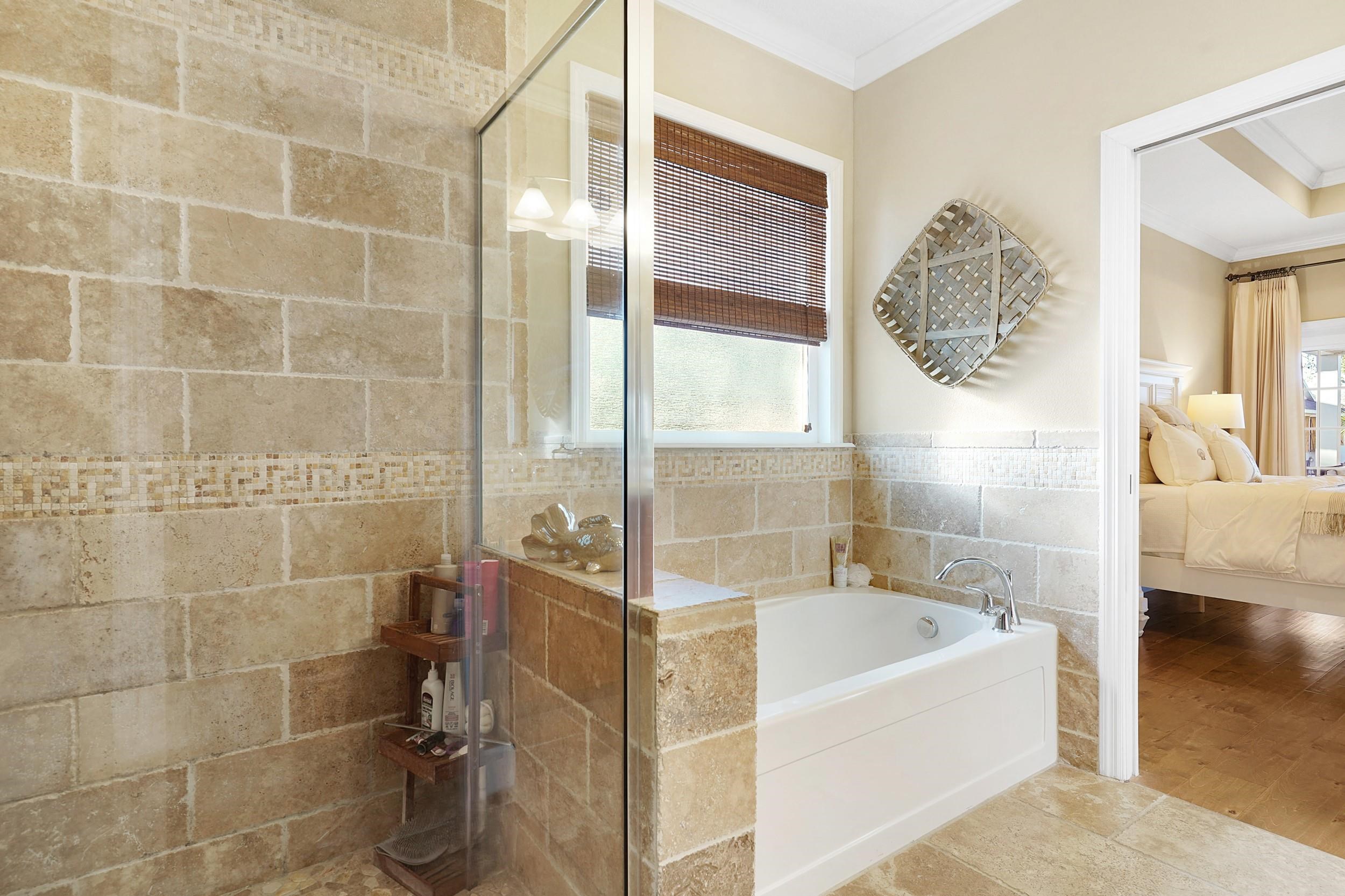 248 Pizarro Road St. Augustine, FL 32080 - Photo 29 of 53 Ensuite bathroom with a garden tub, ornamental molding, a shower stall, and healthy amount of natural light