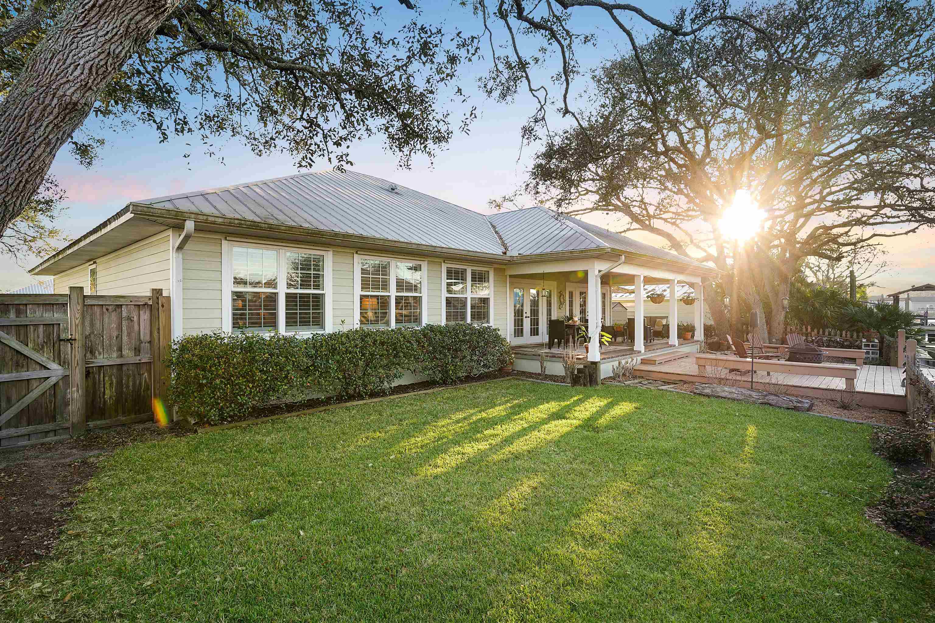 248 Pizarro Road St. Augustine, FL 32080 - Photo 39 of 53 Back of house with a metal roof, a deck, and a gate