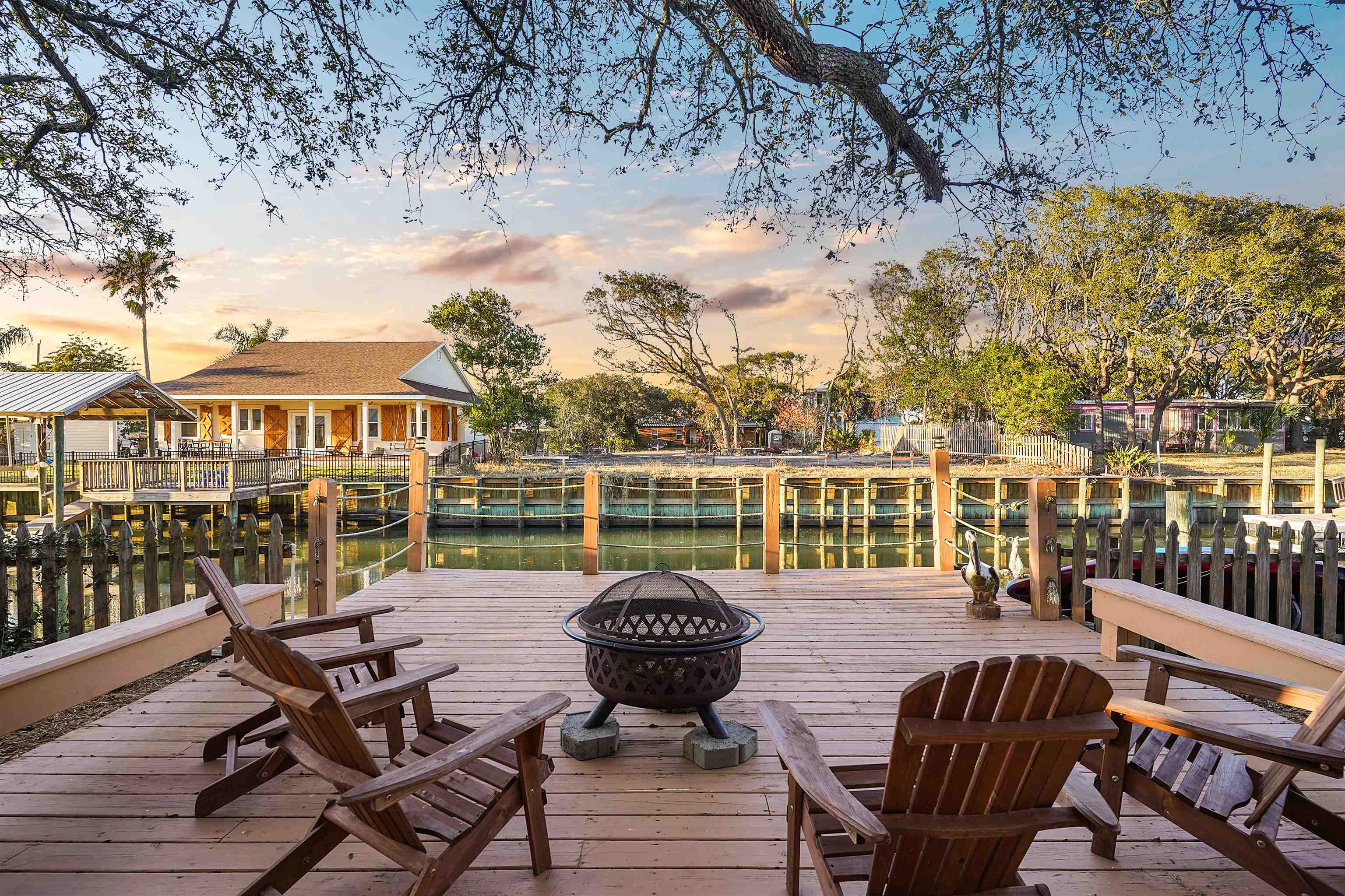 248 Pizarro Road St. Augustine, FL 32080 - Photo 41 of 53 Deck at dusk with an outdoor fire pit and a water view