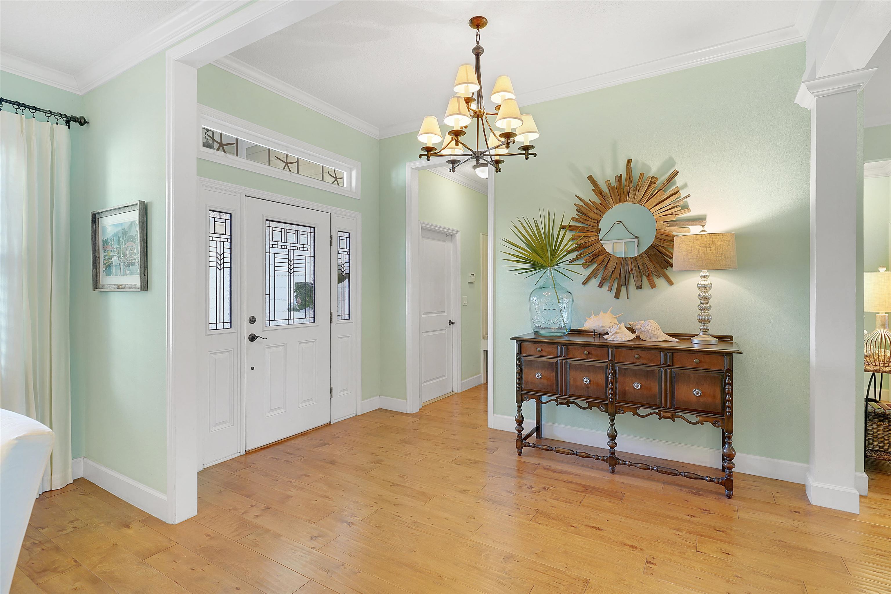 248 Pizarro Road St. Augustine, FL 32080 - Photo 7 of 53 Foyer featuring light wood finished floors, ornamental molding, and suspended lighting