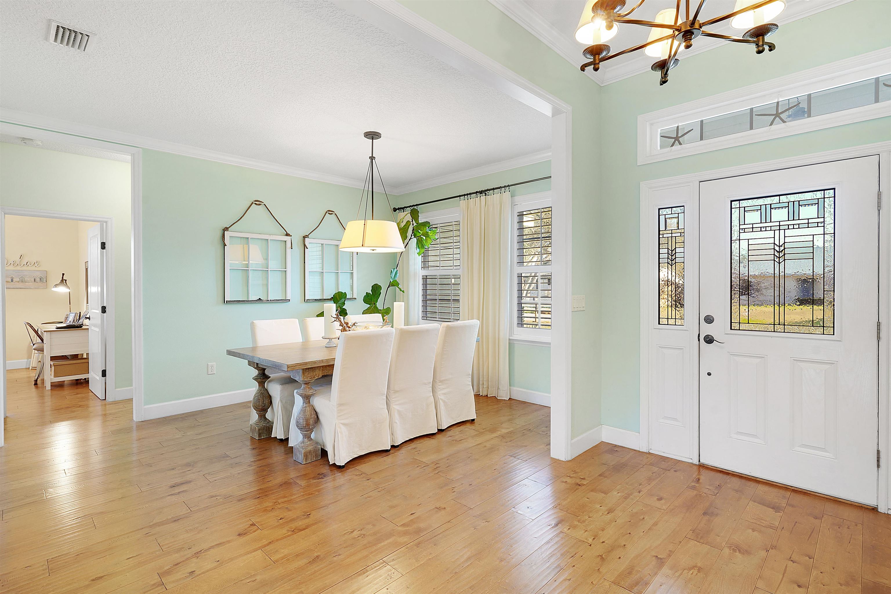 248 Pizarro Road St. Augustine, FL 32080 - Photo 9 of 53 Dining space featuring light wood-style flooring, a chandelier, and ornamental molding