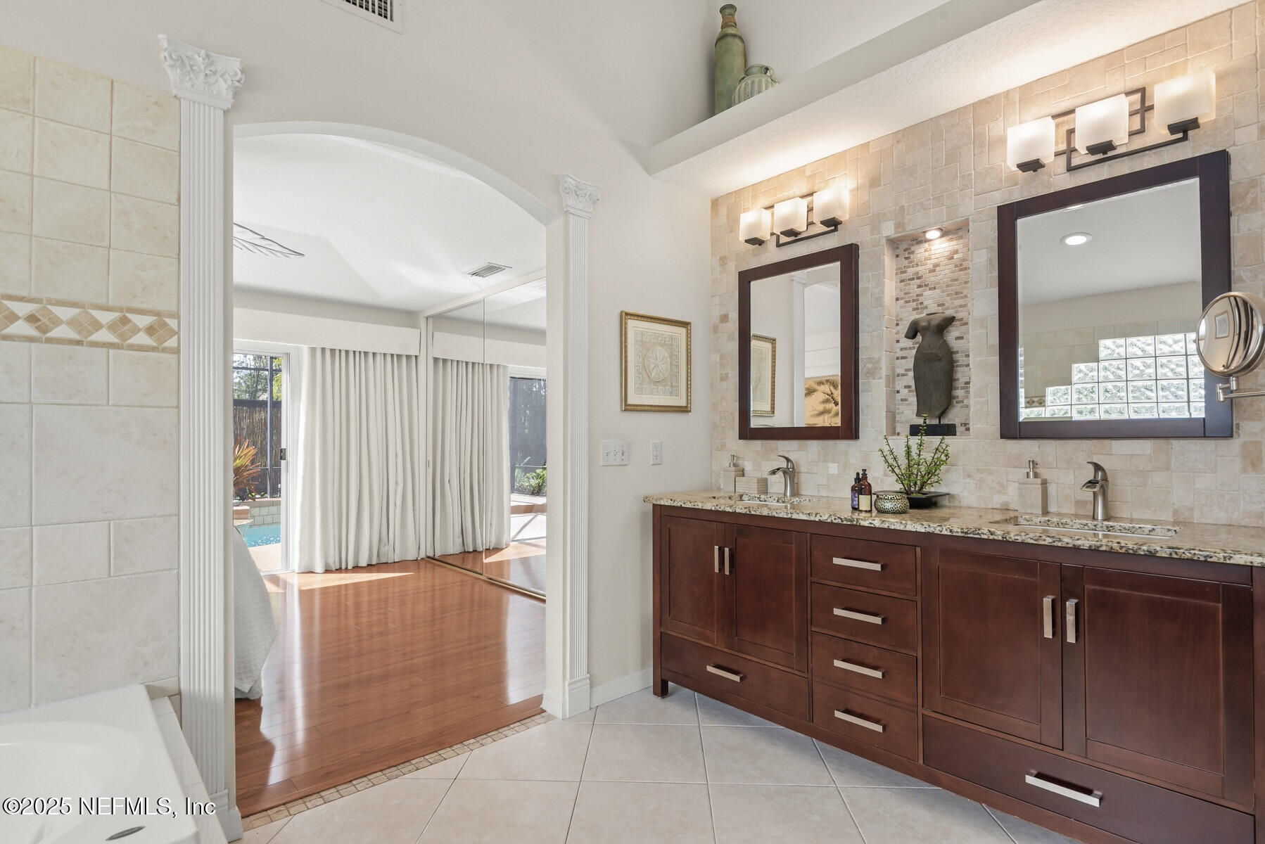 28 Spanish Waters Drive Ormond Beach, FL 32176 - Photo 14 of 44 a bathroom with a double vanity sink and a mirror