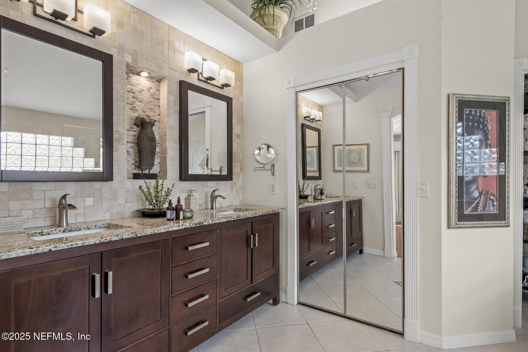 28 Spanish Waters Drive Ormond Beach, FL 32176 - Photo 15 of 44 a bathroom with a double vanity sink and mirror