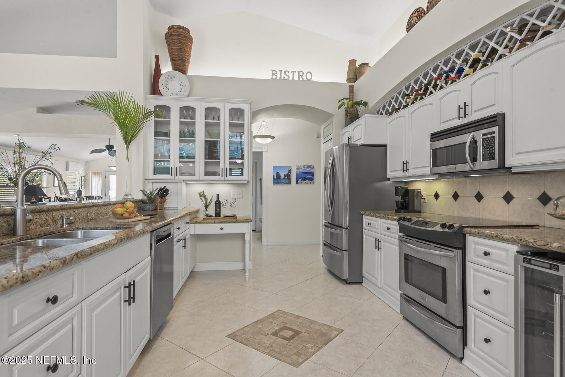 28 Spanish Waters Drive Ormond Beach, FL 32176 - Photo 17 of 44 a kitchen with stainless steel appliances granite countertop a sink and stove top oven