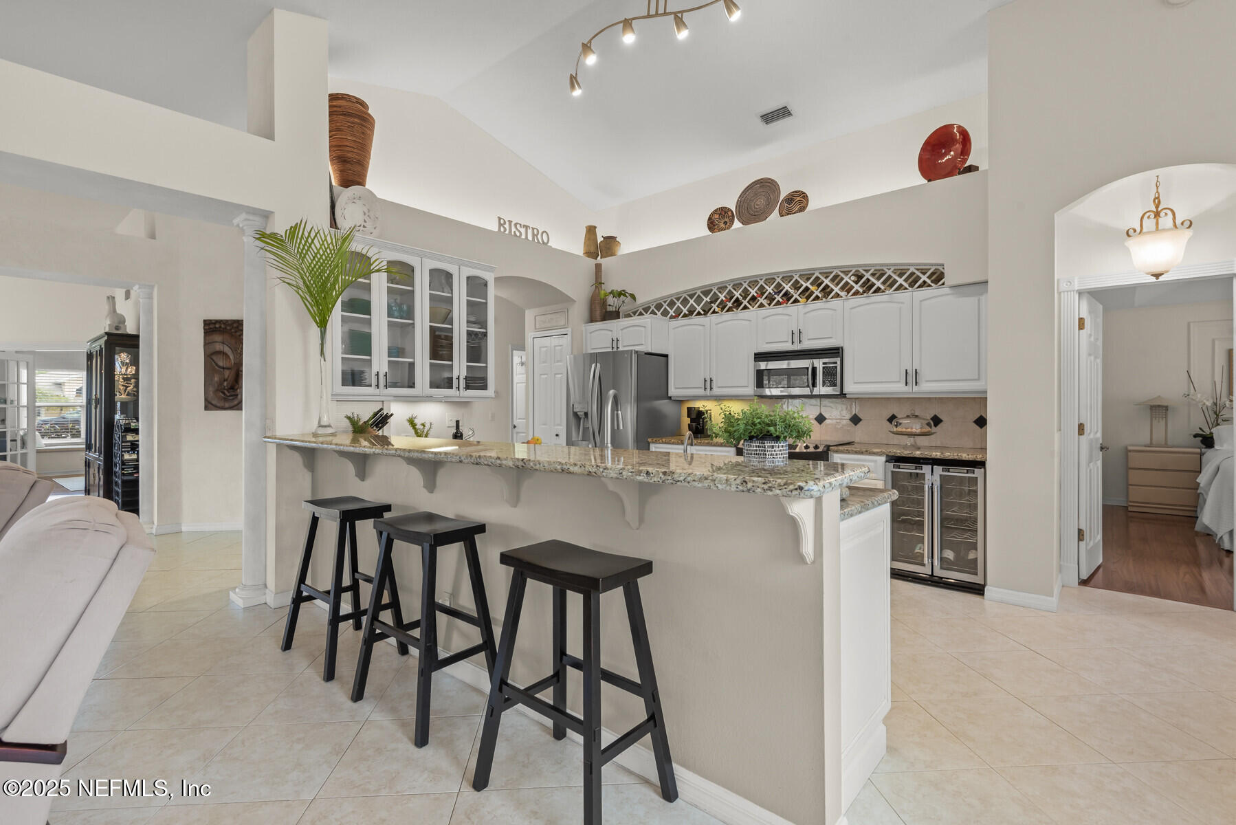 28 Spanish Waters Drive Ormond Beach, FL 32176 - Photo 22 of 44 a kitchen with stainless steel appliances kitchen island granite countertop a table chairs sink and cabinets