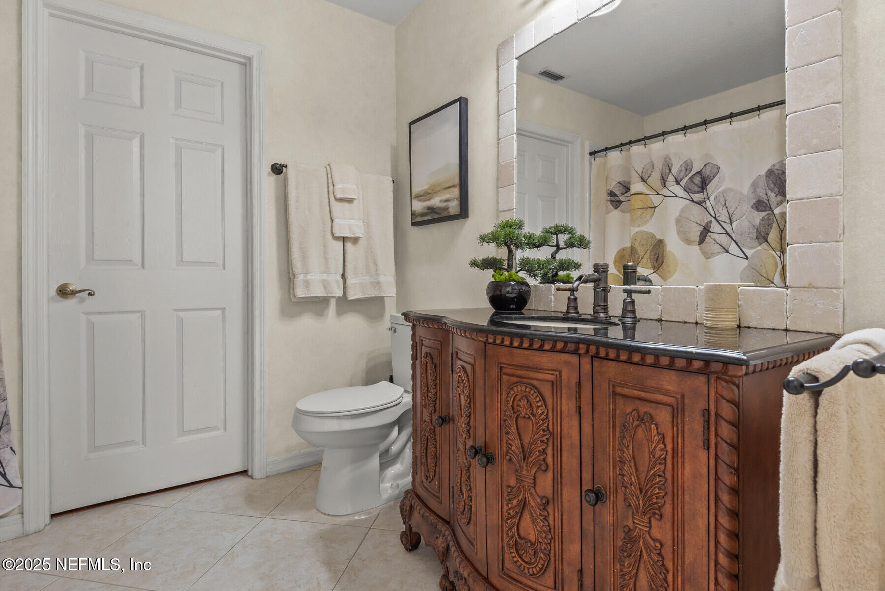 28 Spanish Waters Drive Ormond Beach, FL 32176 - Photo 26 of 44 a bathroom with a toilet a sink and a mirror