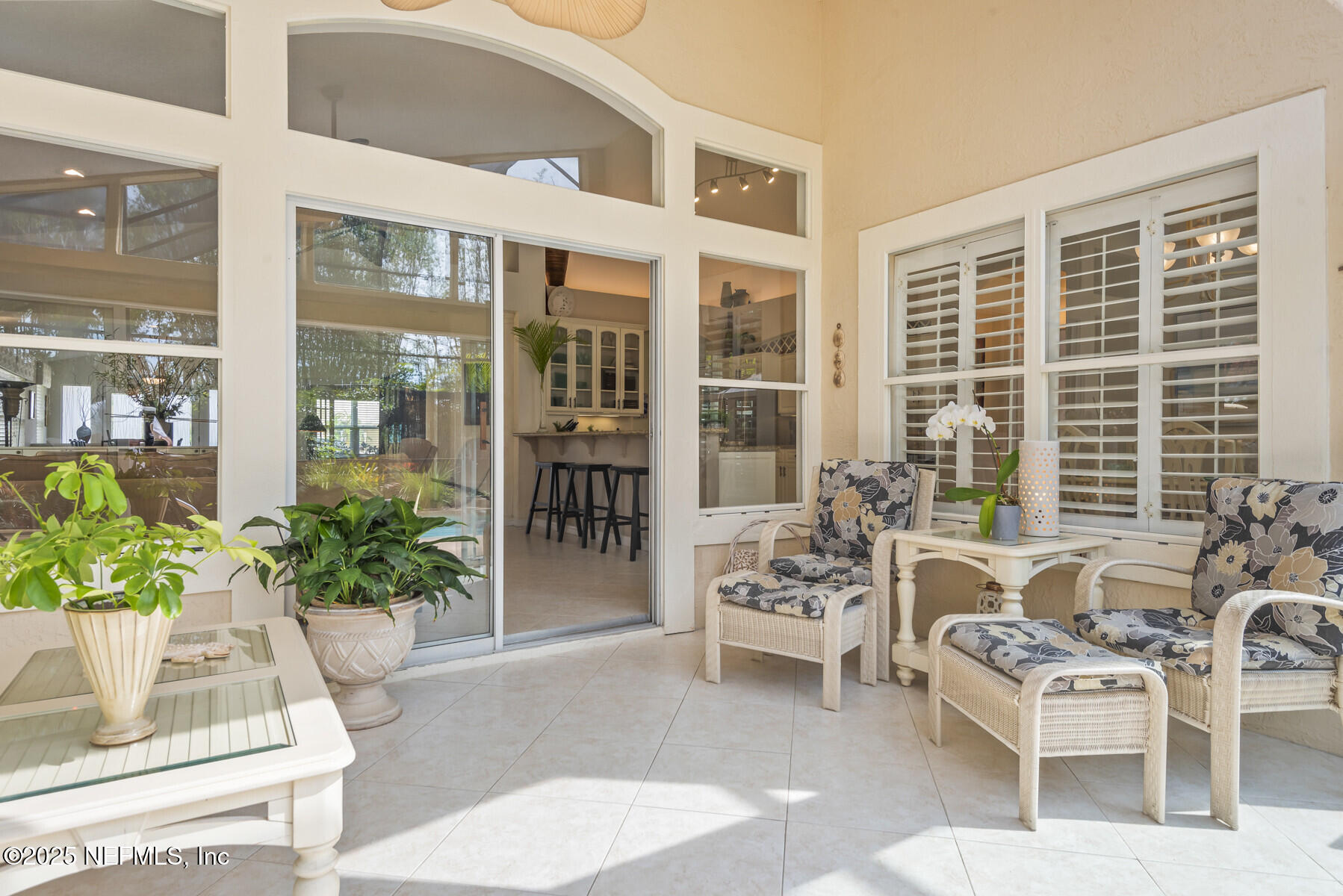28 Spanish Waters Drive Ormond Beach, FL 32176 - Photo 5 of 44 a view of a patio with couches table and chairs and potted plants