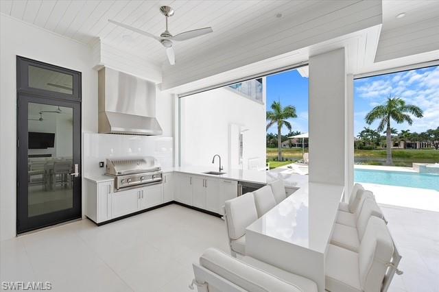 6285 Highcroft Drive Naples, FL 34119 - Photo 12 of 50 a living room with stainless steel appliances furniture and a large window