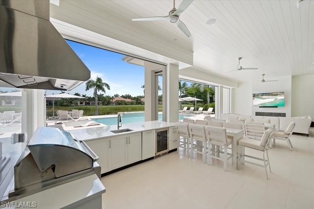 6285 Highcroft Drive Naples, FL 34119 - Photo 13 of 50 a large white kitchen with a large window