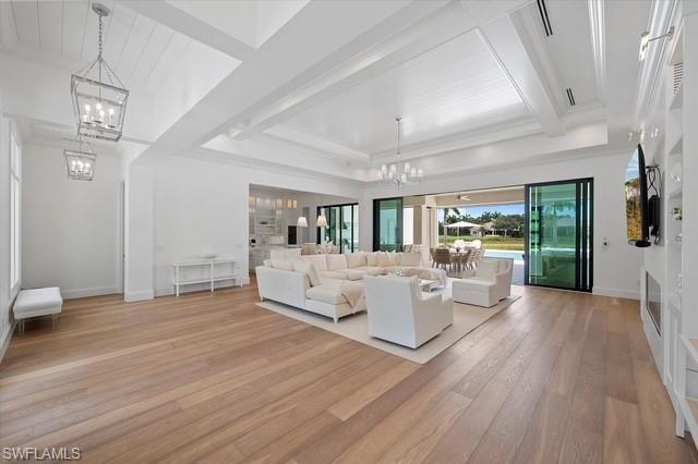6285 Highcroft Drive Naples, FL 34119 - Photo 16 of 50 a living room with furniture and a wooden floor