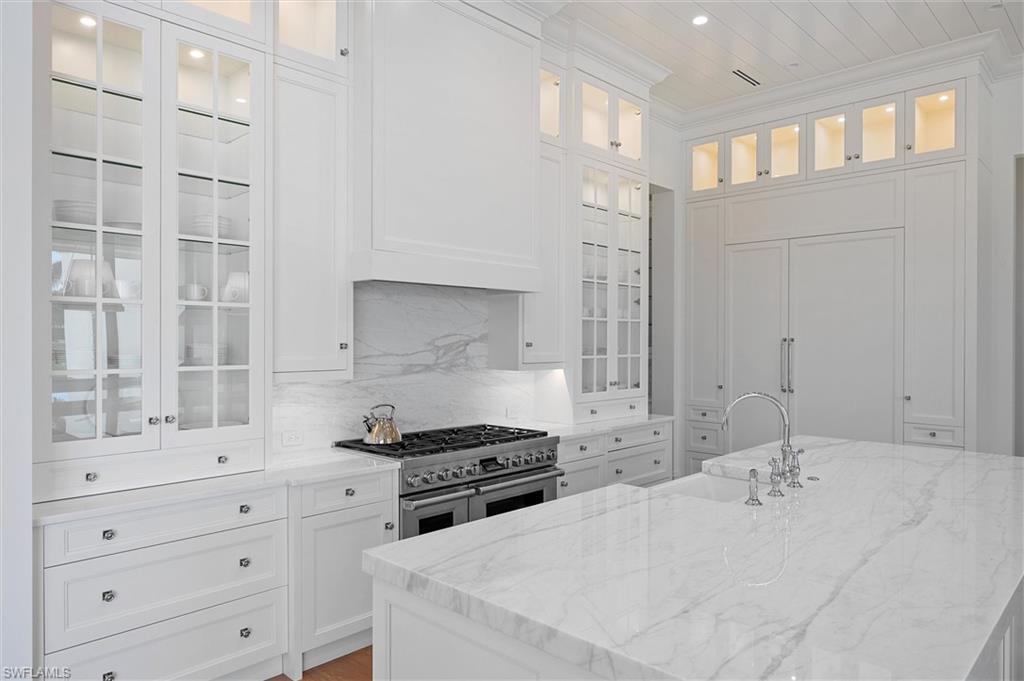 6285 Highcroft Drive Naples, FL 34119 - Photo 21 of 50 a kitchen with cabinets appliances and a window