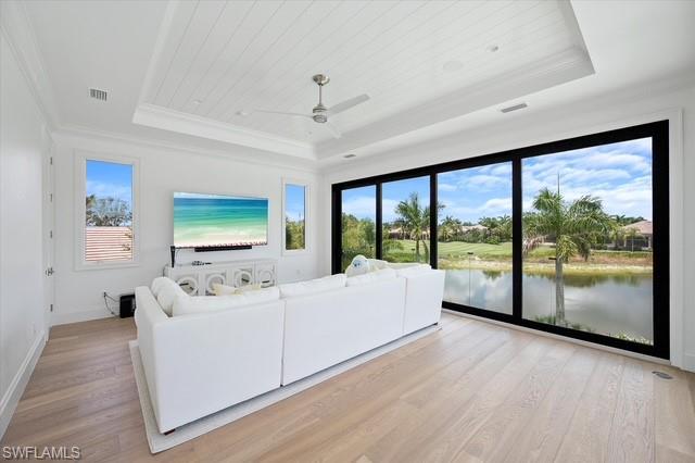 6285 Highcroft Drive Naples, FL 34119 - Photo 26 of 50 a living room with furniture and large windows