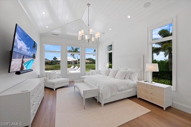 6285 Highcroft Drive Naples, FL 34119 - Photo 28 of 50 a spacious bedroom with a bed and a large window