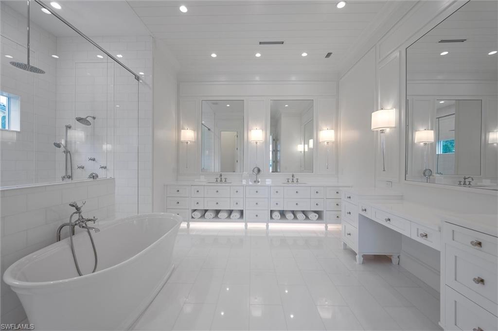 6285 Highcroft Drive Naples, FL 34119 - Photo 30 of 50 a large spacious bathroom with a large tub a sink double vanity