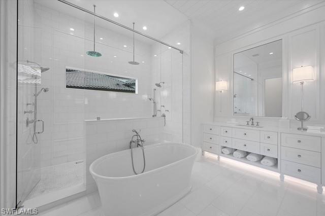 6285 Highcroft Drive Naples, FL 34119 - Photo 31 of 50 a bathroom with a bathtub and a shower