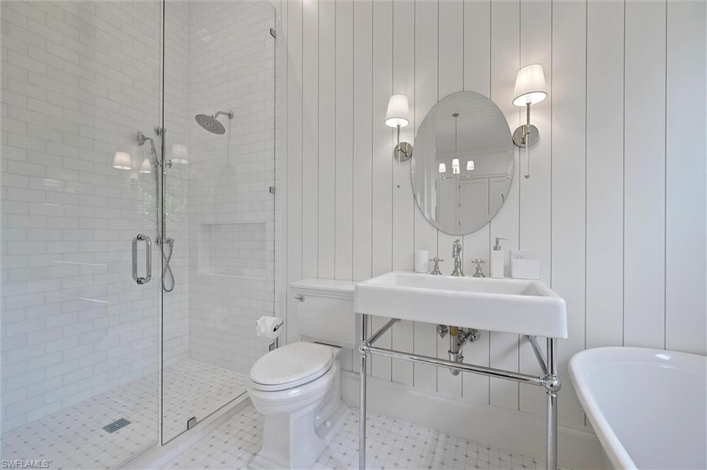 6285 Highcroft Drive Naples, FL 34119 - Photo 36 of 50 a bathroom with a sink a toilet and shower