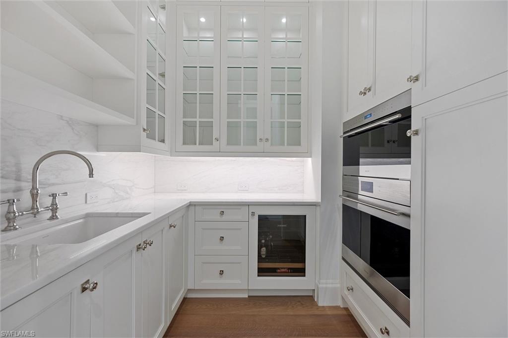 6285 Highcroft Drive Naples, FL 34119 - Photo 42 of 50 a kitchen with stainless steel appliances granite countertop a stove and a sink