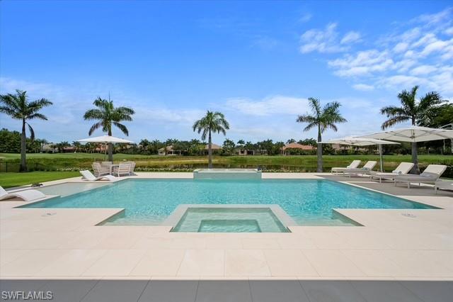 6285 Highcroft Drive Naples, FL 34119 - Photo 9 of 50 a view of a swimming pool with a yard