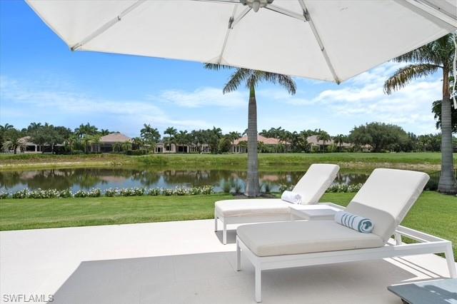 6285 Highcroft Drive Naples, FL 34119 - Photo 10 of 50 a view of a table and chairs under an umbrella