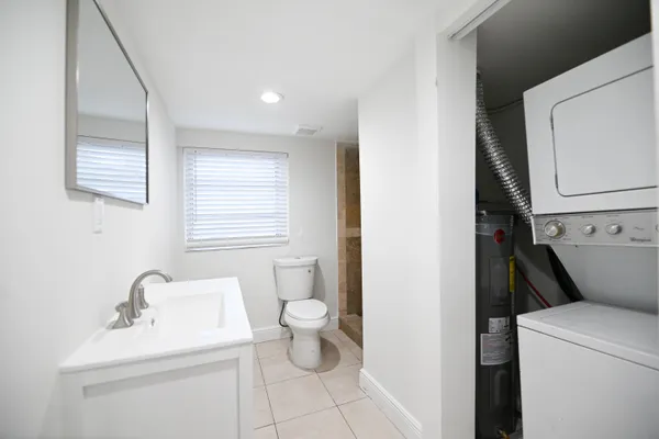 a bathroom with a sink toilet and a mirror