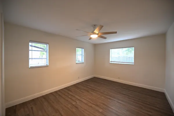 a view of a room with wooden floor and window