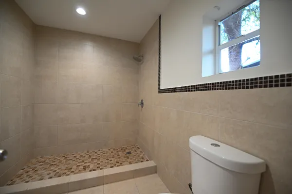 a bathroom with a toilet and a shower