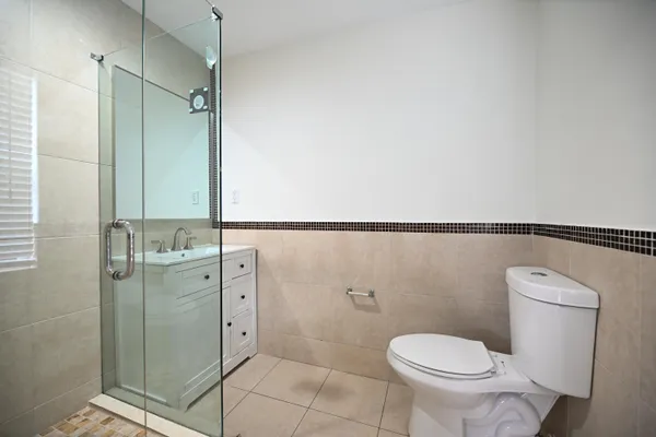 a bathroom with a toilet and a shower