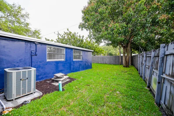 a view of a backyard with a garden and deck